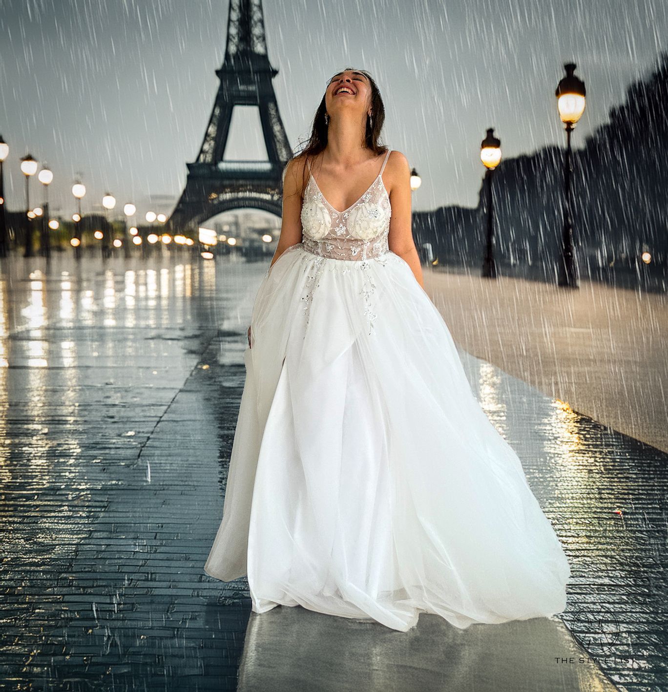 A woman in a wedding dress is standing in the rain in front of the Eiffel tower.