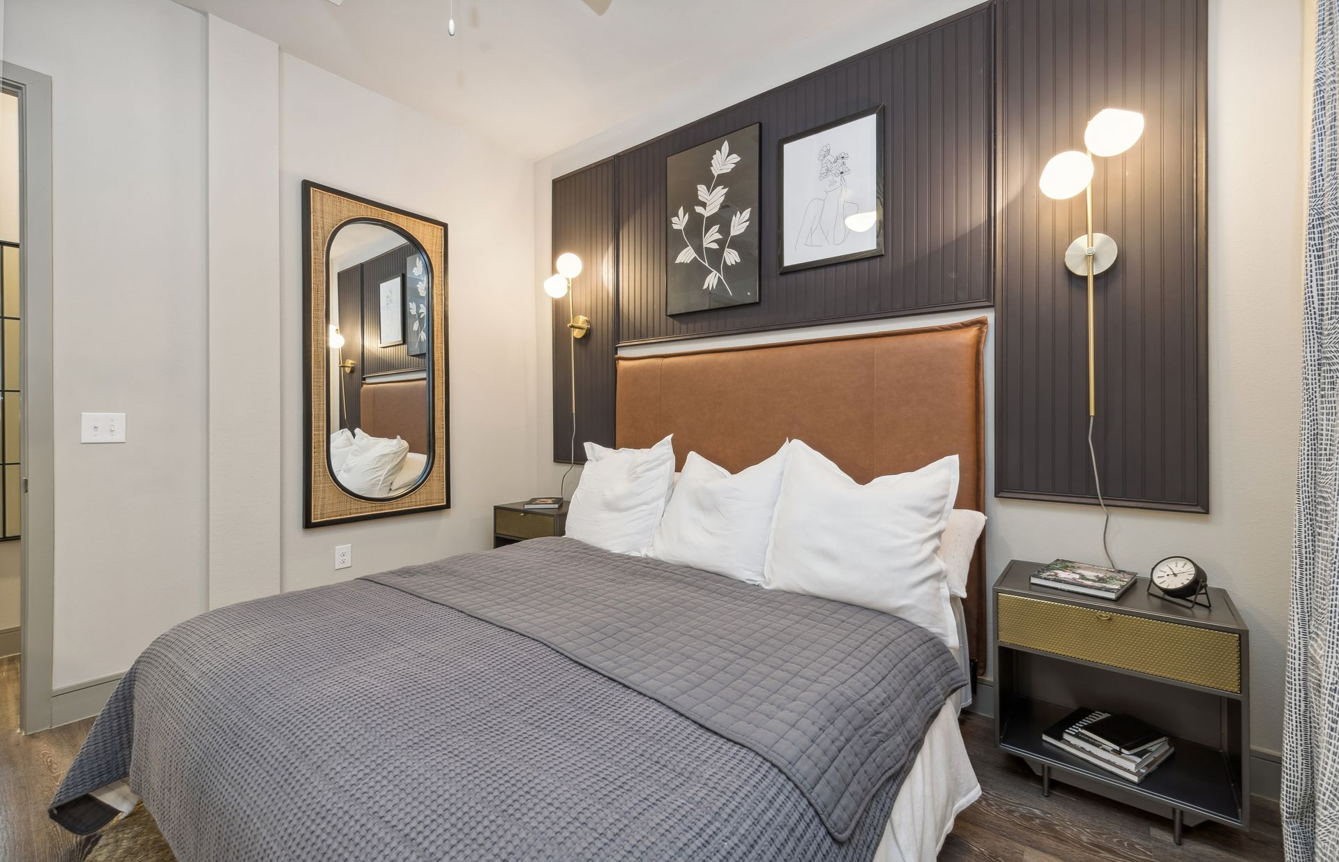 Well-furnished bedroom in a model home at One90 Gateway in Plano, TX.