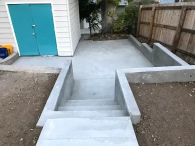 A set of stairs leading up to a shed in a backyard.
