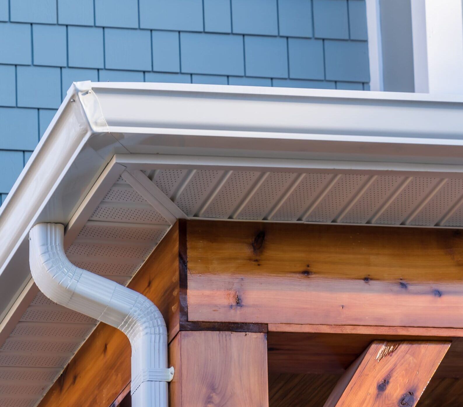 A white gutter on the side of a house