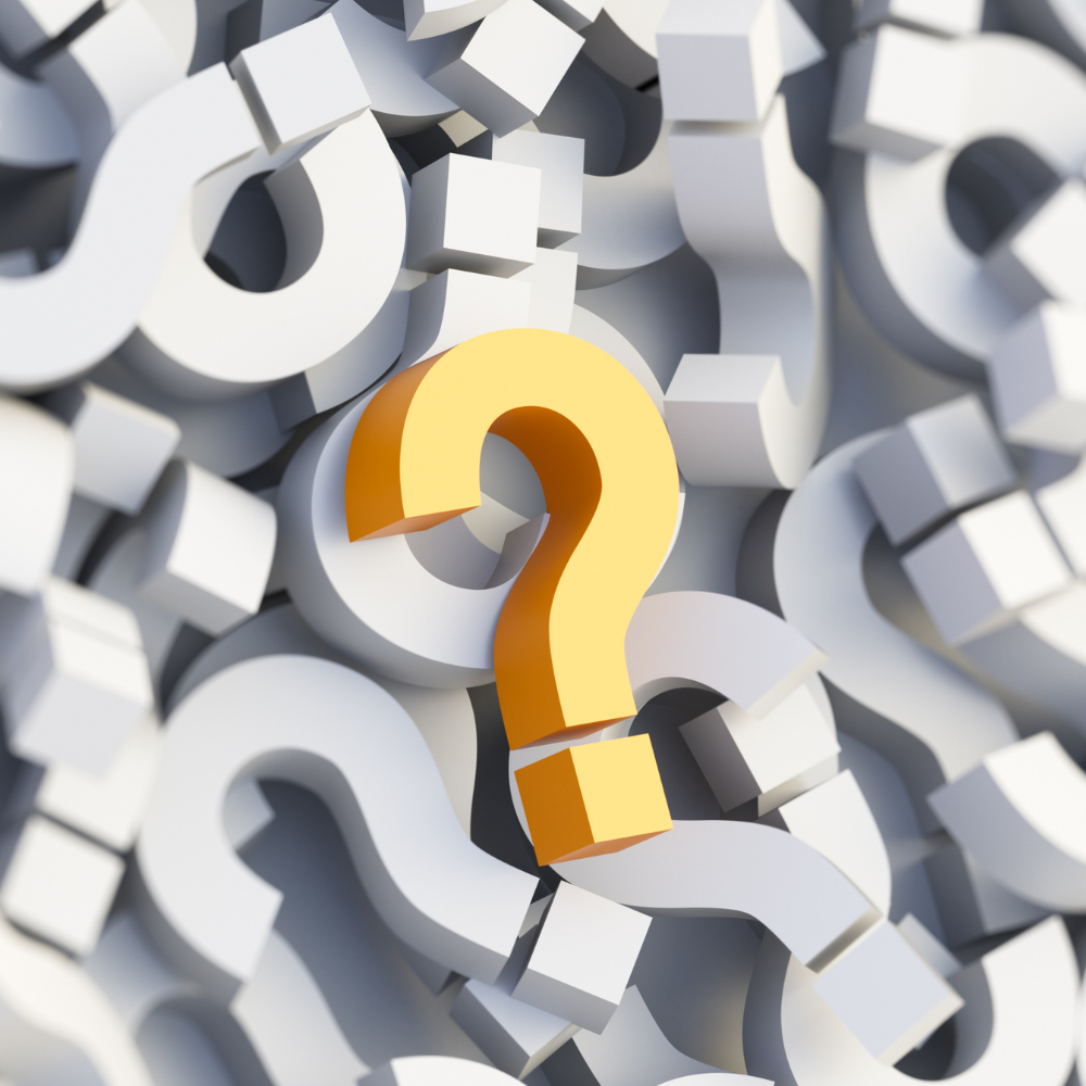 A single bright gold question mark stands out against a blurred background of many white question marks.
