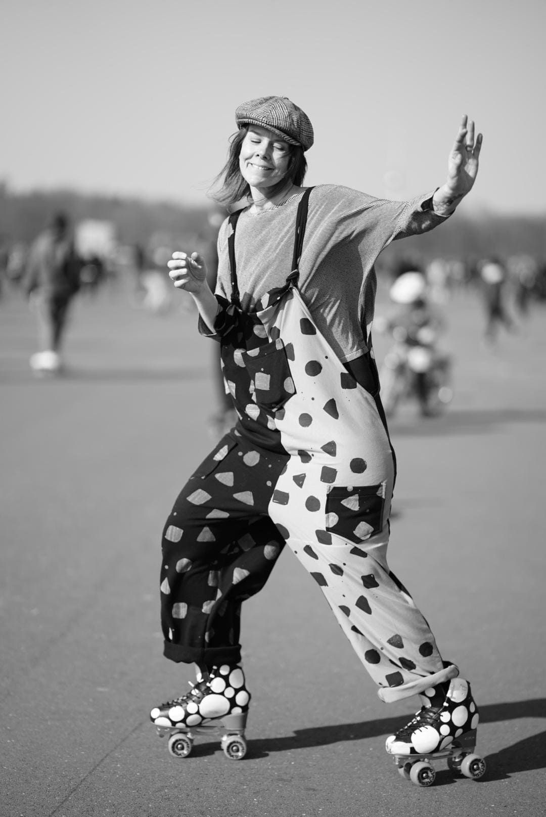 a woman in a clown costume is rollerblading on a street .