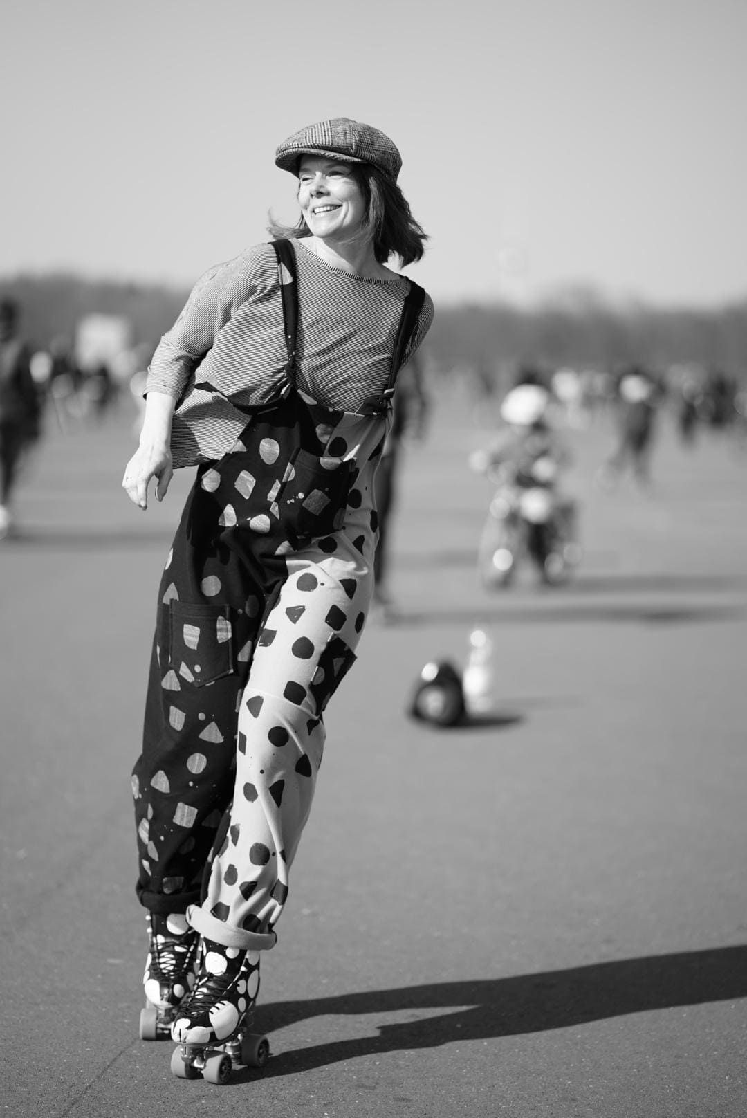 a woman in a clown costume is rollerblading on a street .