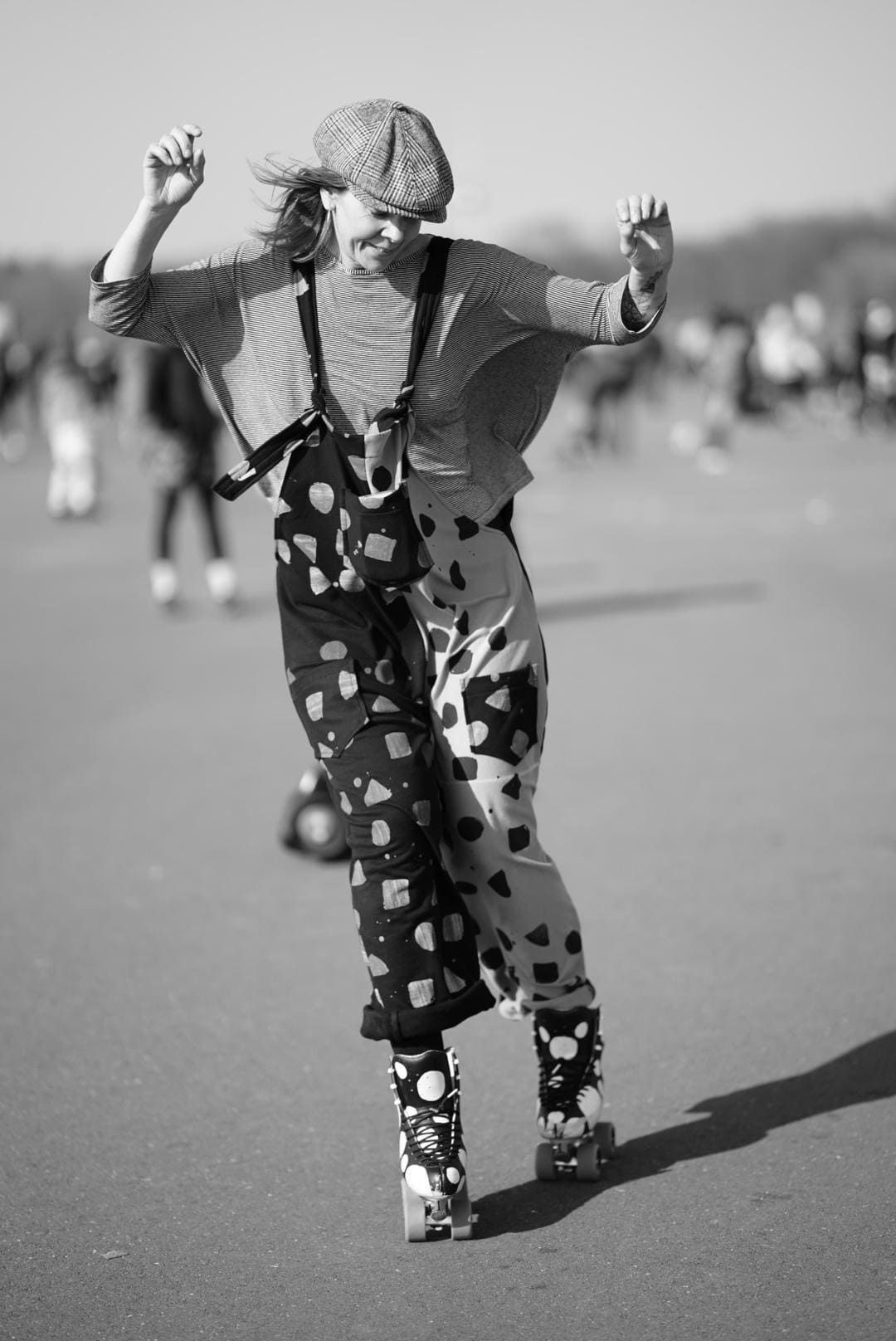a black and white photo of a person rollerblading
