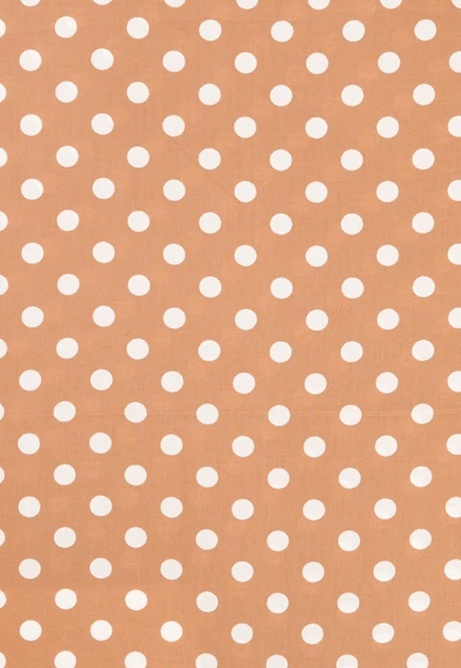 A brown background with white polka dots on it