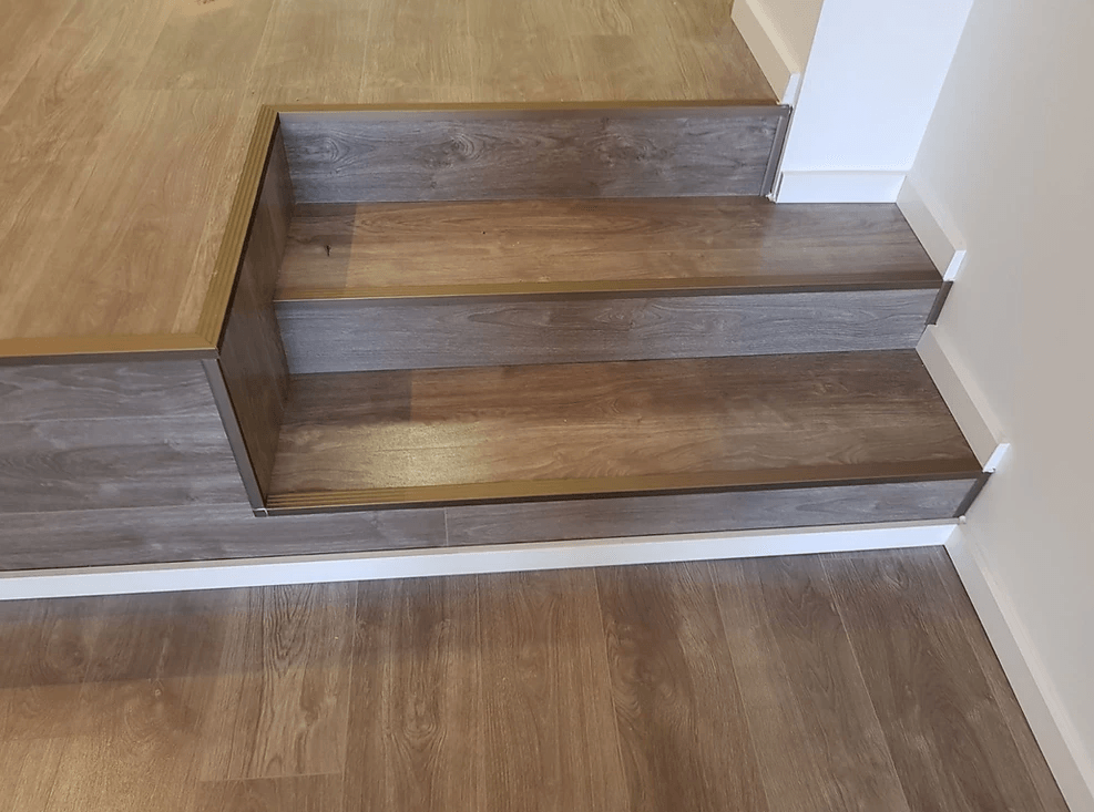 A close up of a wooden staircase in a house.