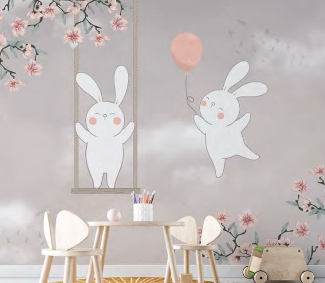 A child 's room with two rabbits on a swing and a table and chairs.
