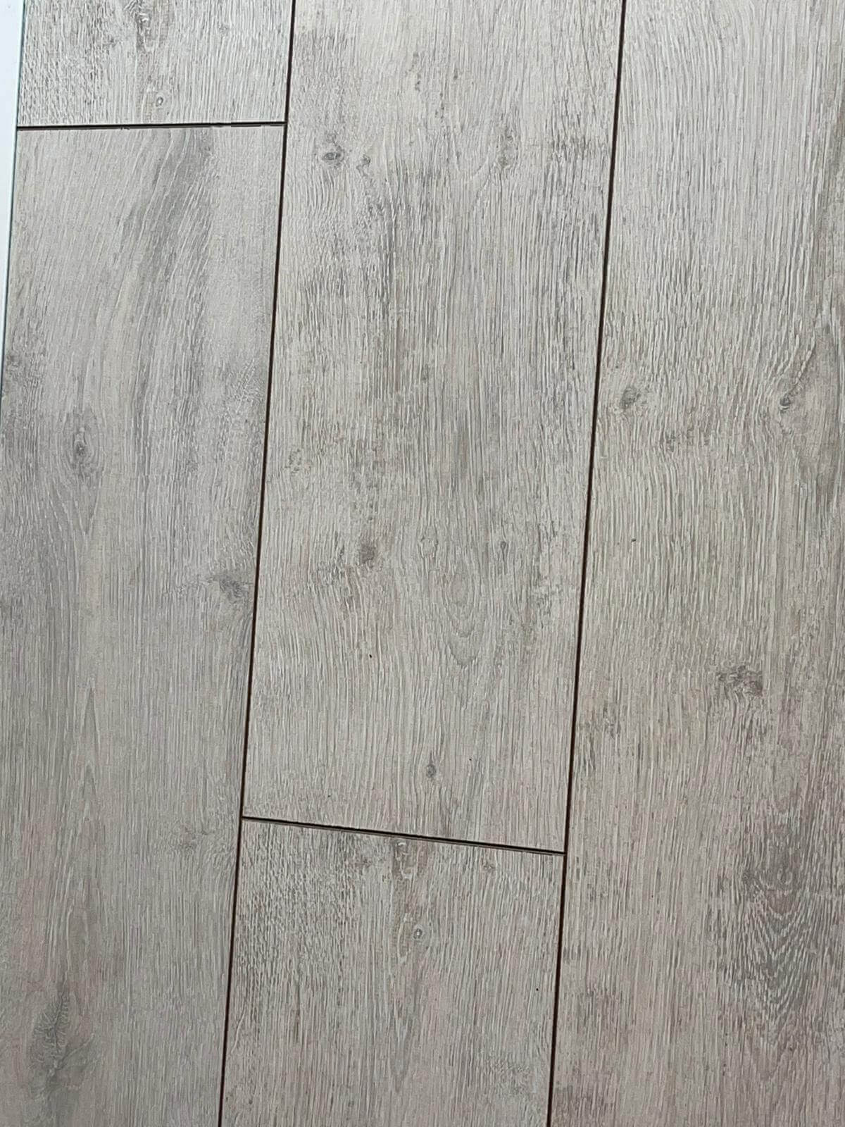 A close up of a tile floor that looks like wood.
