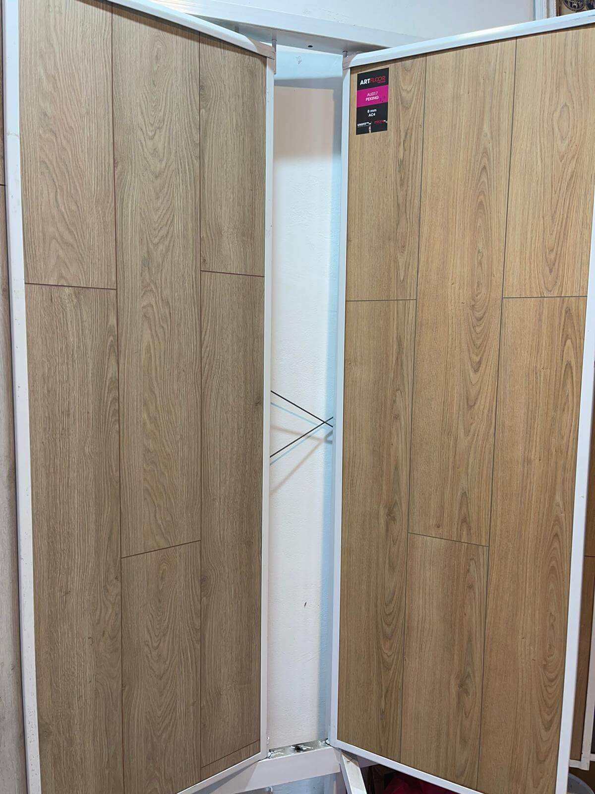 A room divider made of wooden panels and a white frame.