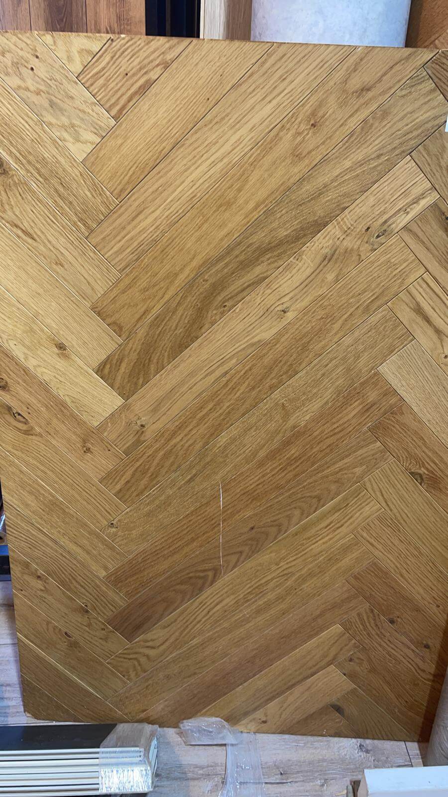 A close up of a piece of wood with a herringbone pattern.