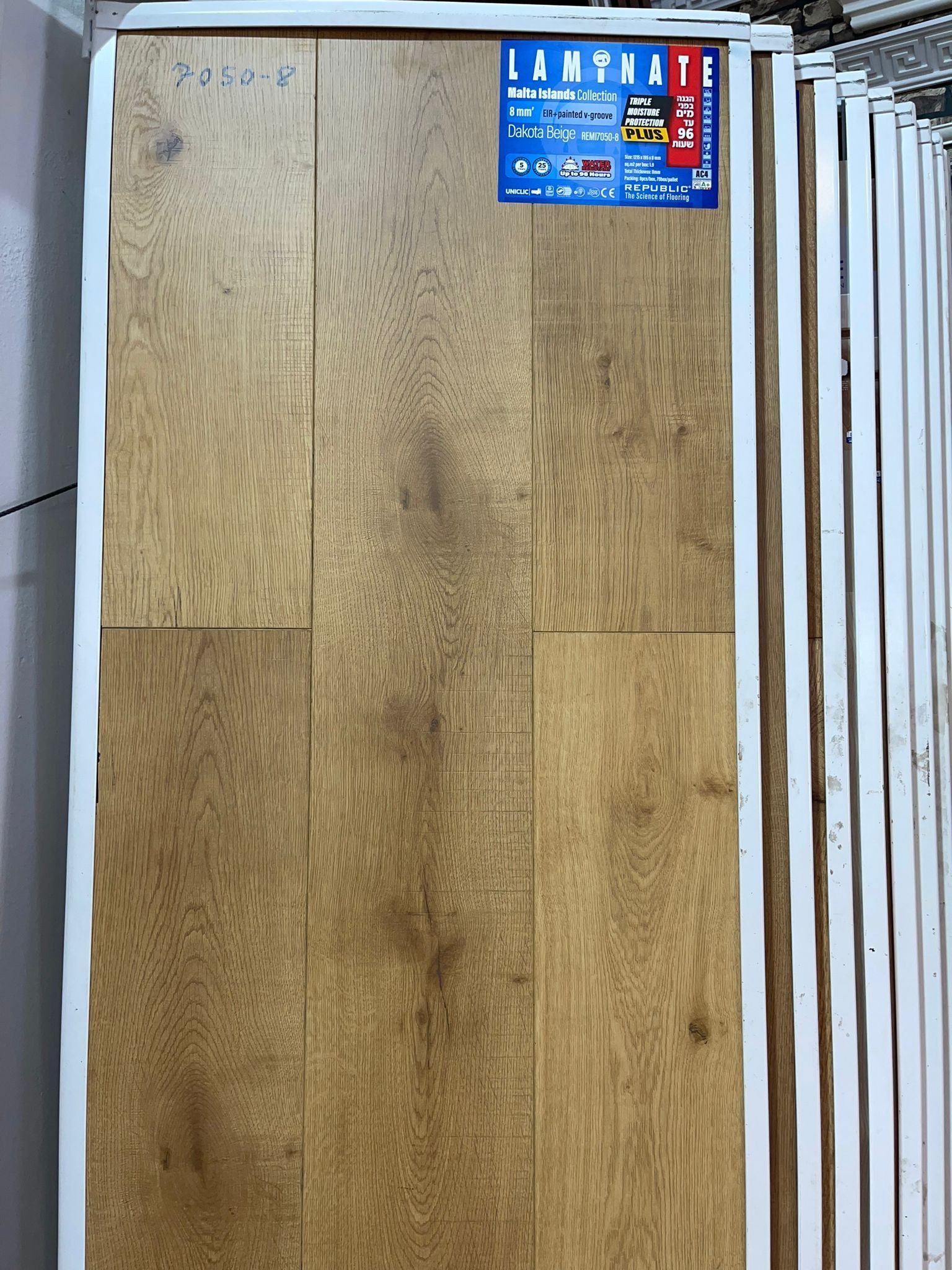 A wooden wall with a blue sign on it.