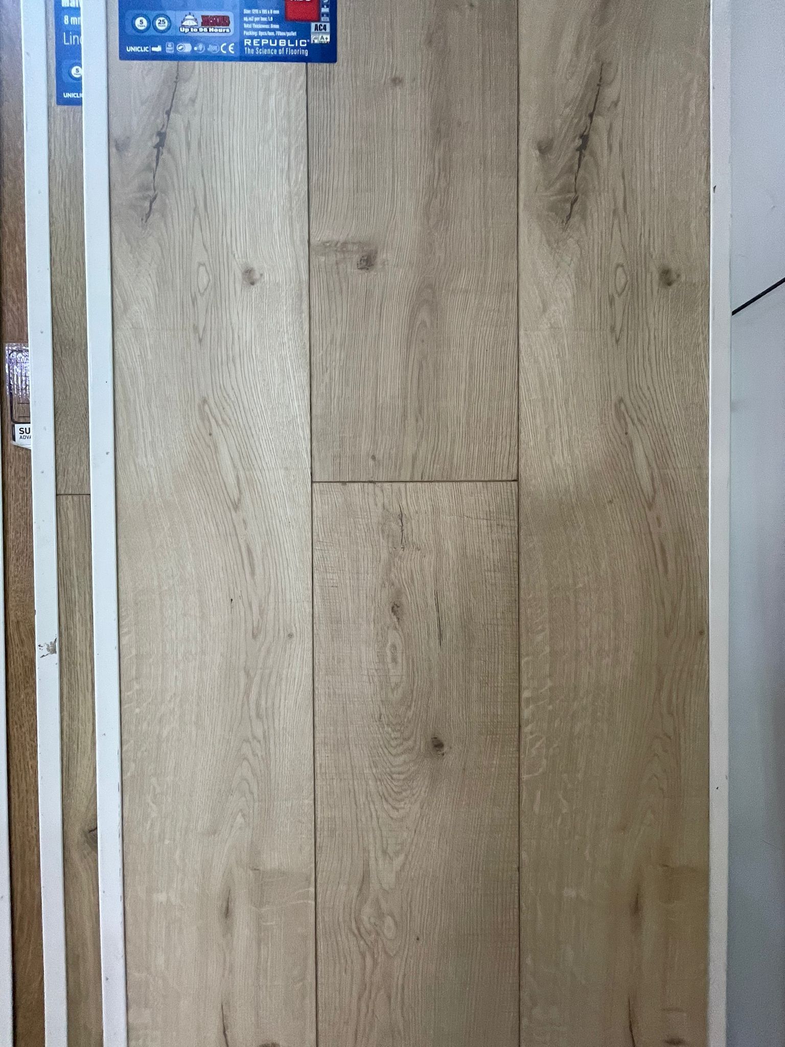 A close up of a wooden door with a sticker on it.