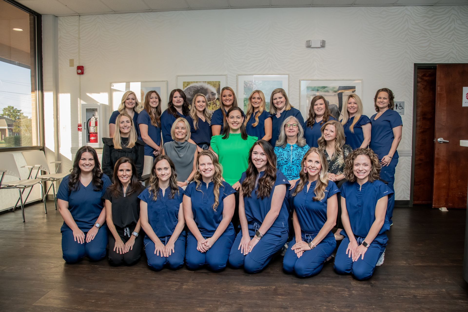 A group of women in scrubs are posing for a picture.