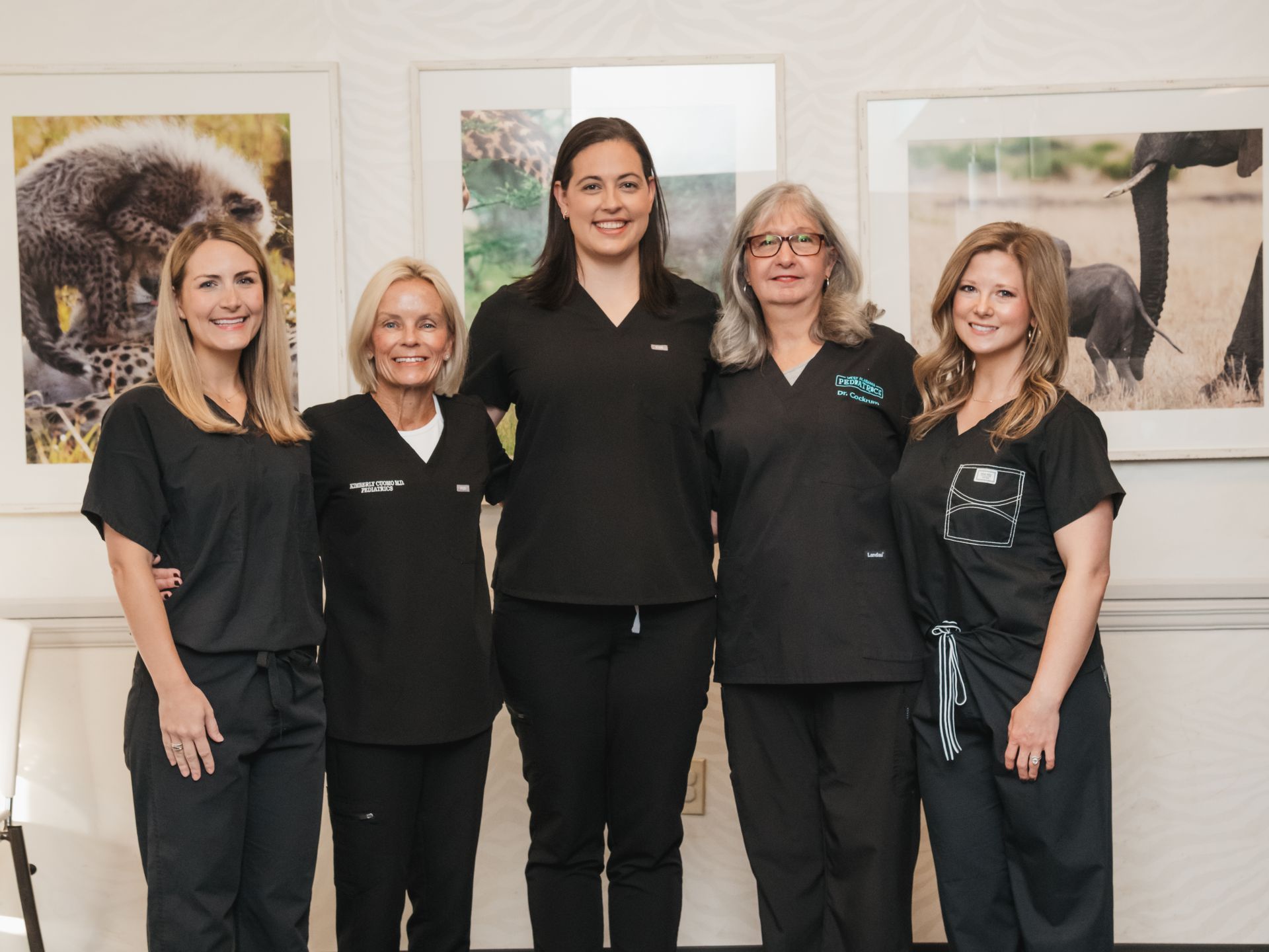 A group of women in scrubs are posing for a picture.