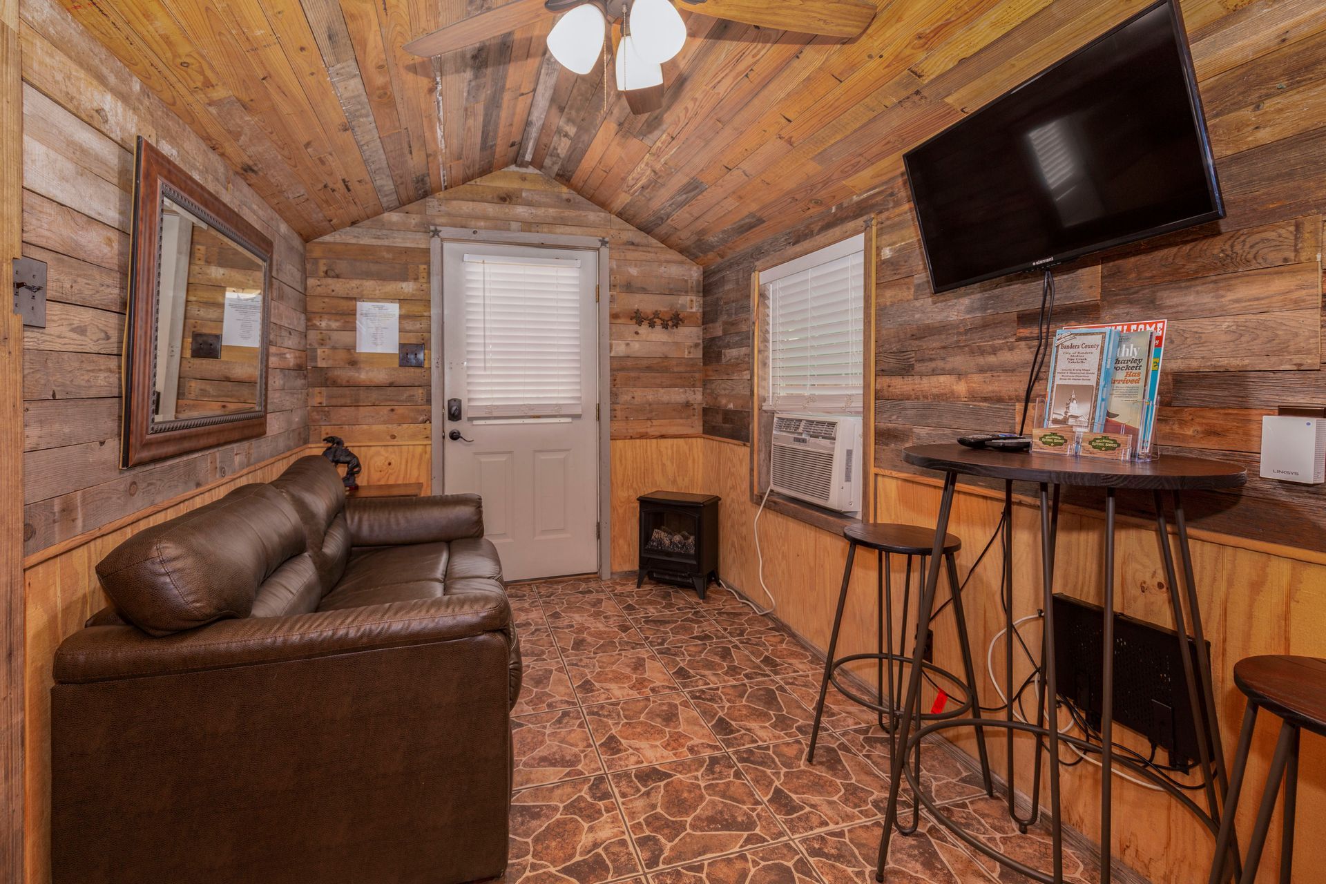 A living room with a couch and a flat screen tv.