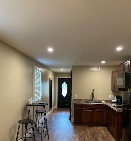 A kitchen with a table and stools in it