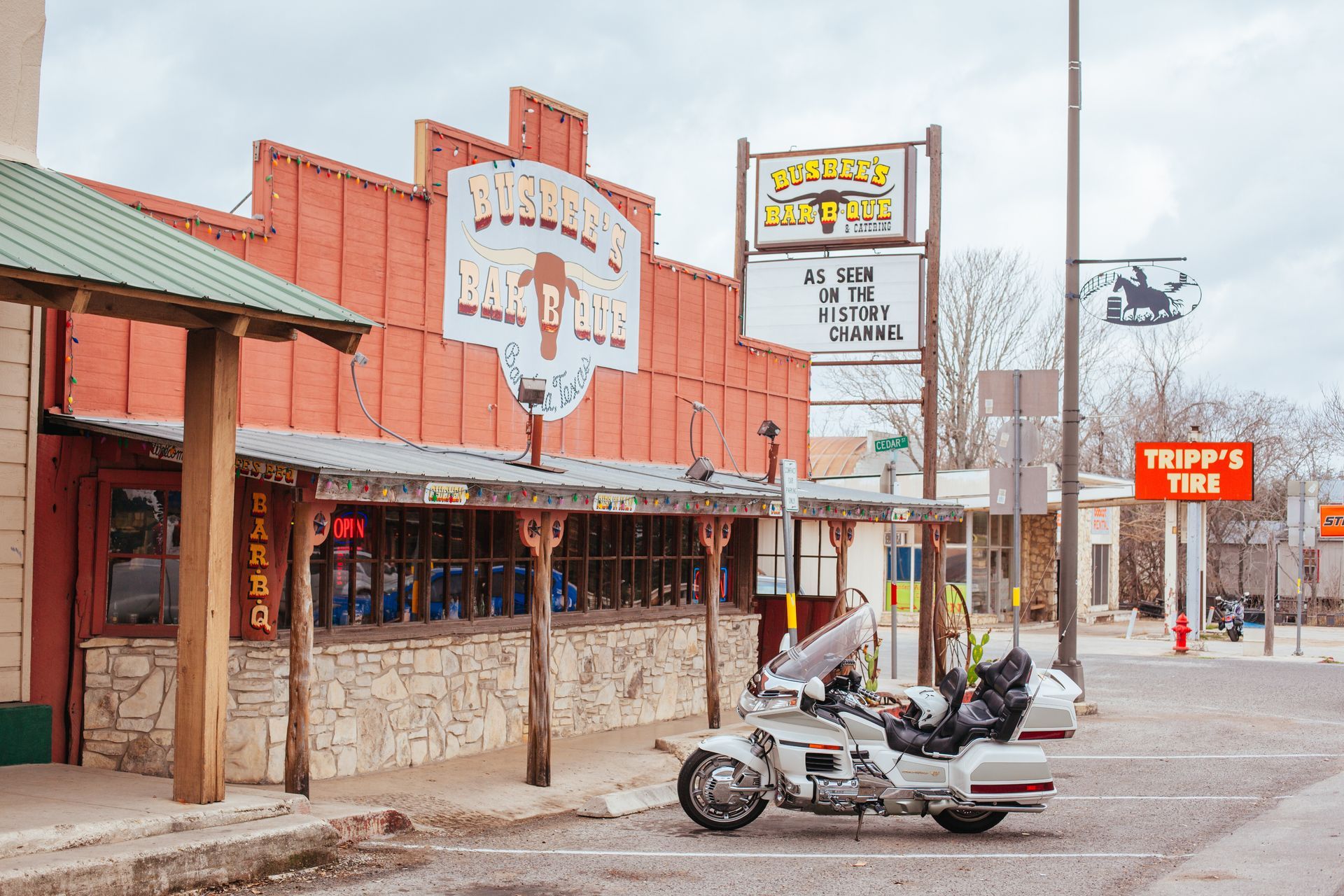 A motorcycle is parked in front of a restaurant.