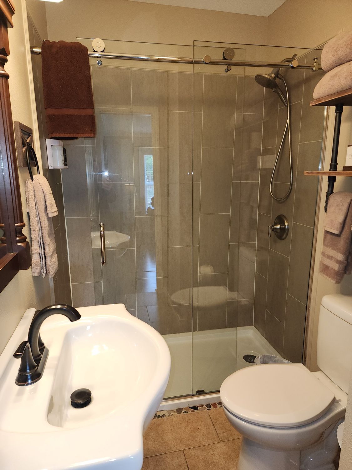 A bathroom with a toilet a sink and a shower