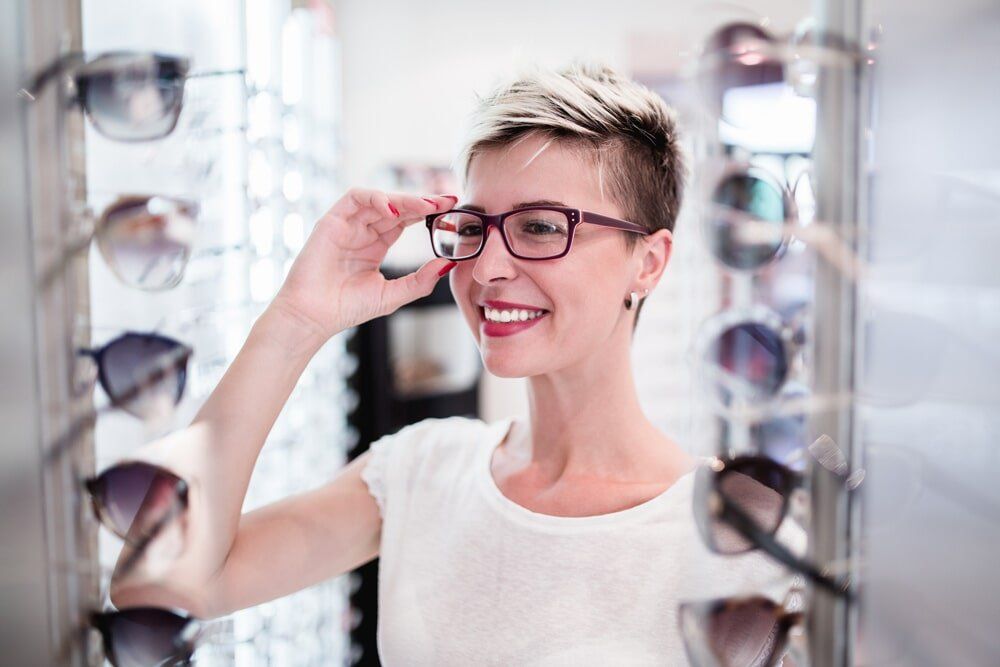 Woman Trying On Glasses - Clear Optometry In Bargara, QLD