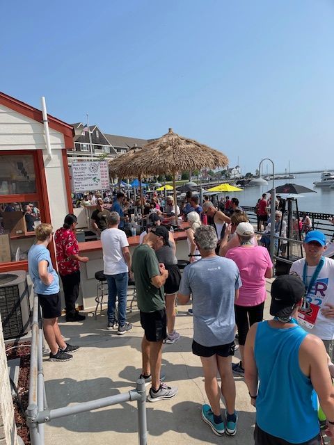 A group of people are toasting with drinks in a bar.