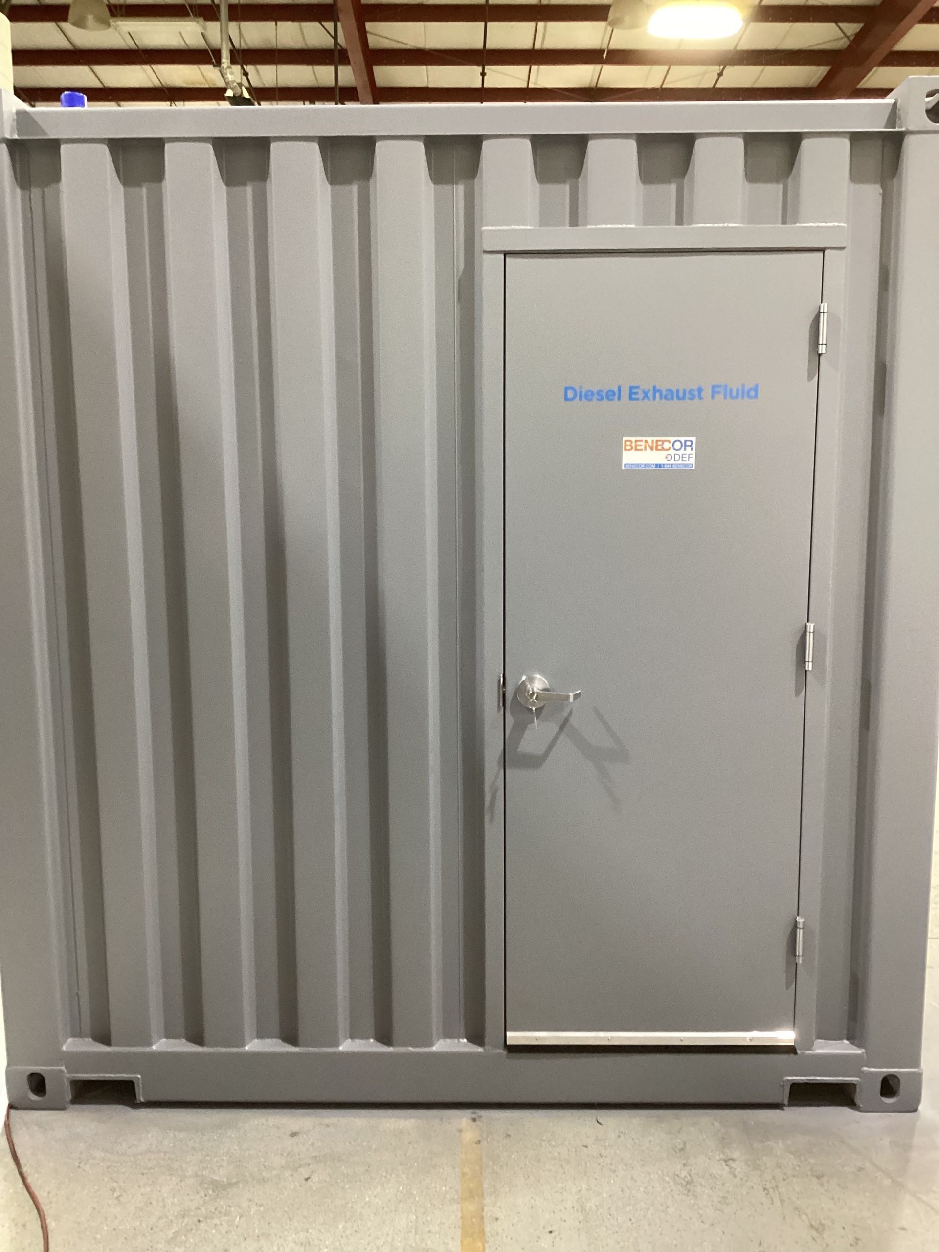 Gray shipping container with a gray door; the door reads 