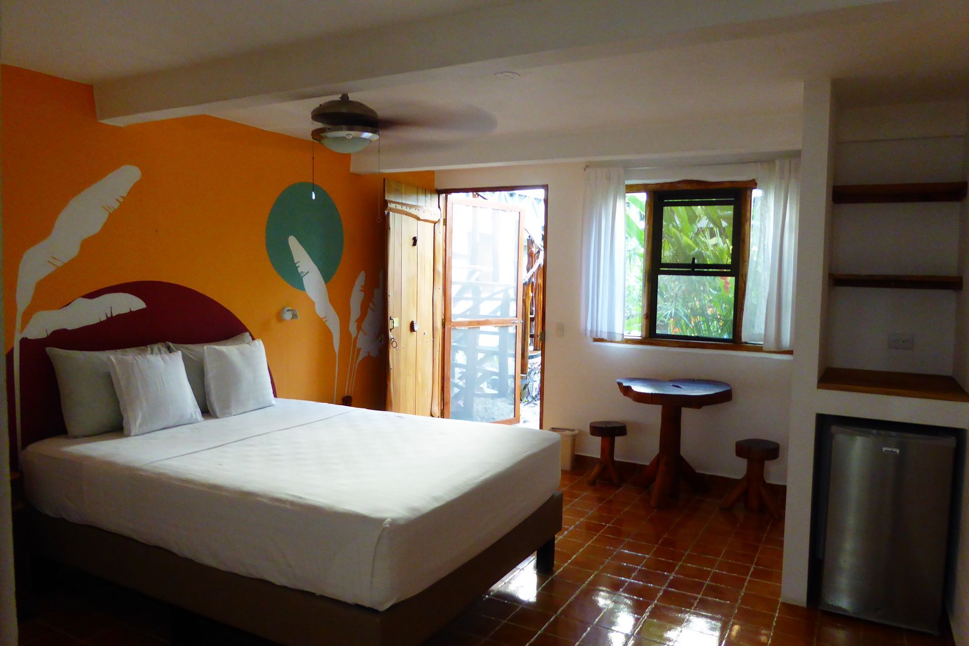 A bedroom with a large bed and a table