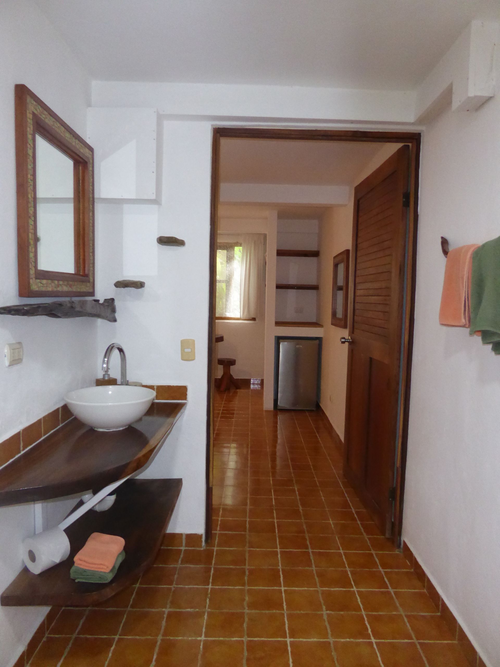 A bathroom with a sink and a mirror on the wall