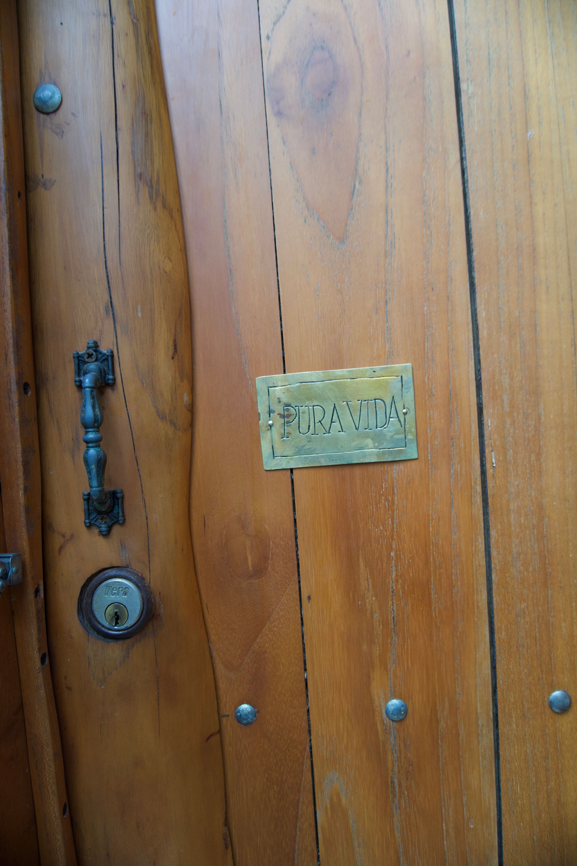 A close up of a wooden door with a sign on it