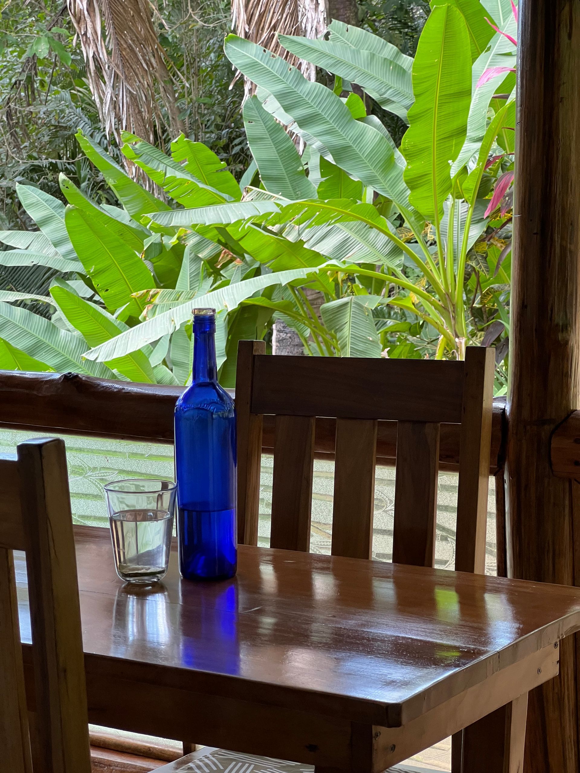 A wooden table with a blue bottle on it