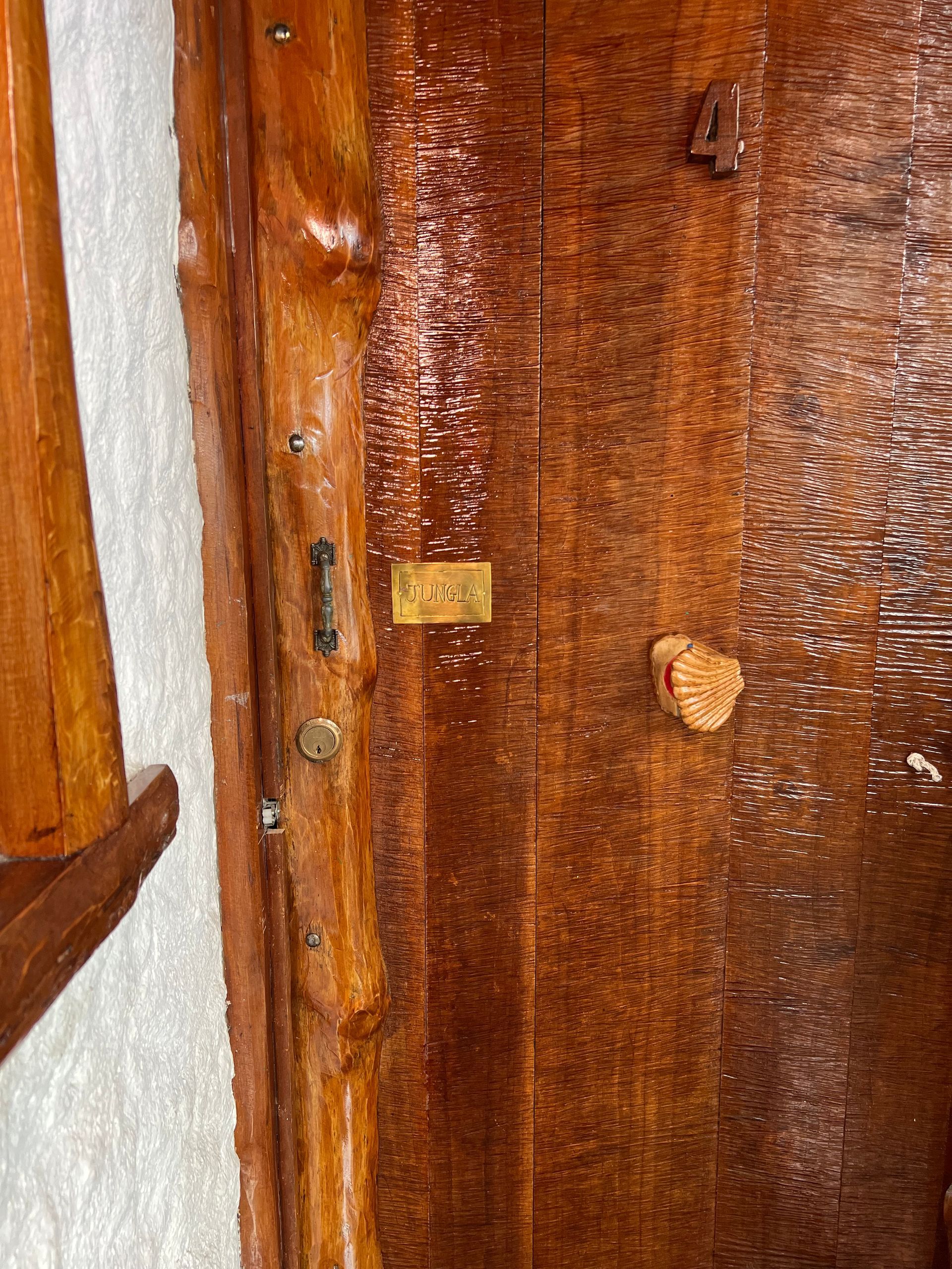 A close up of a wooden door with a key in it.