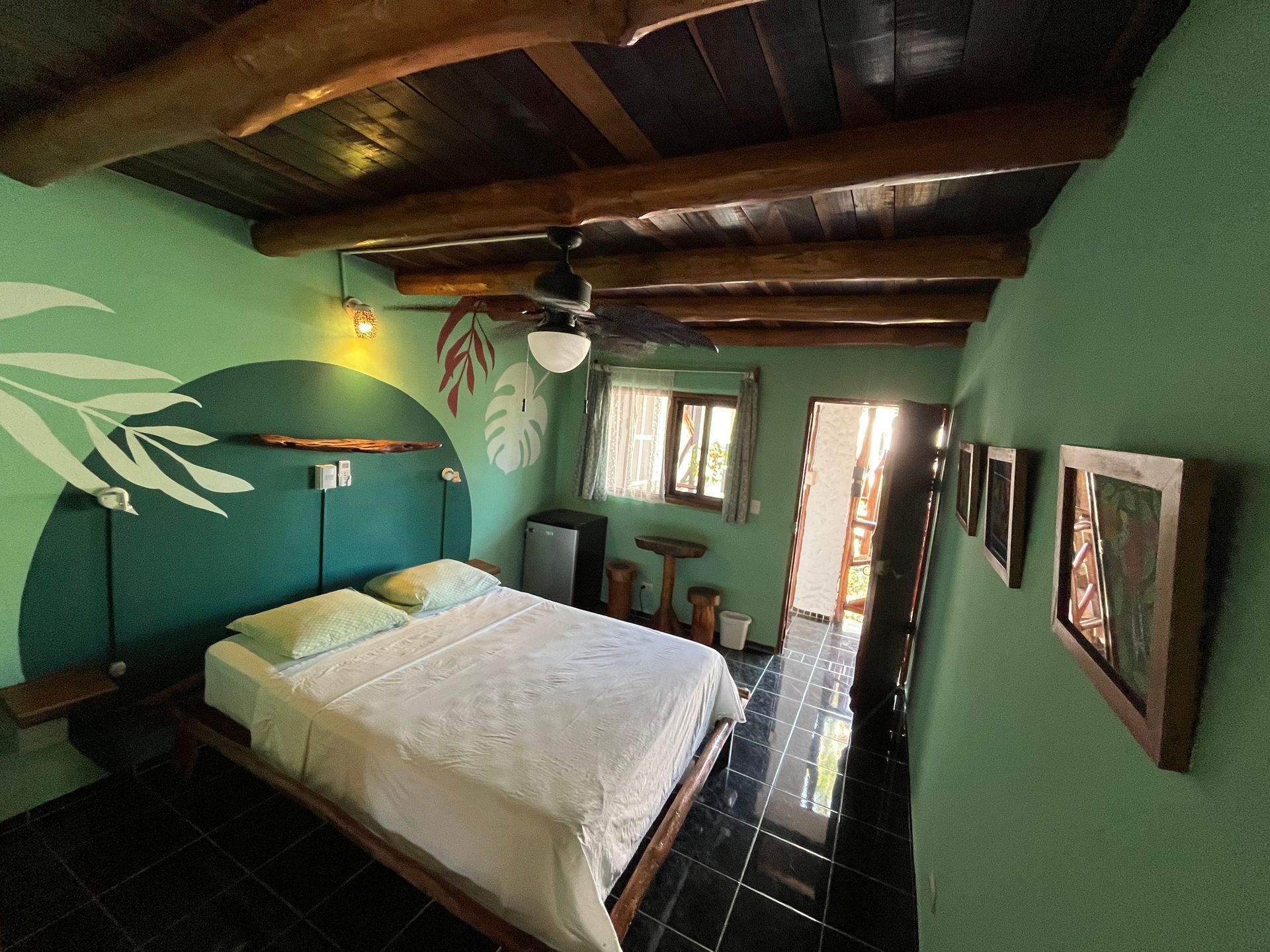 A bedroom with a bed and a ceiling fan