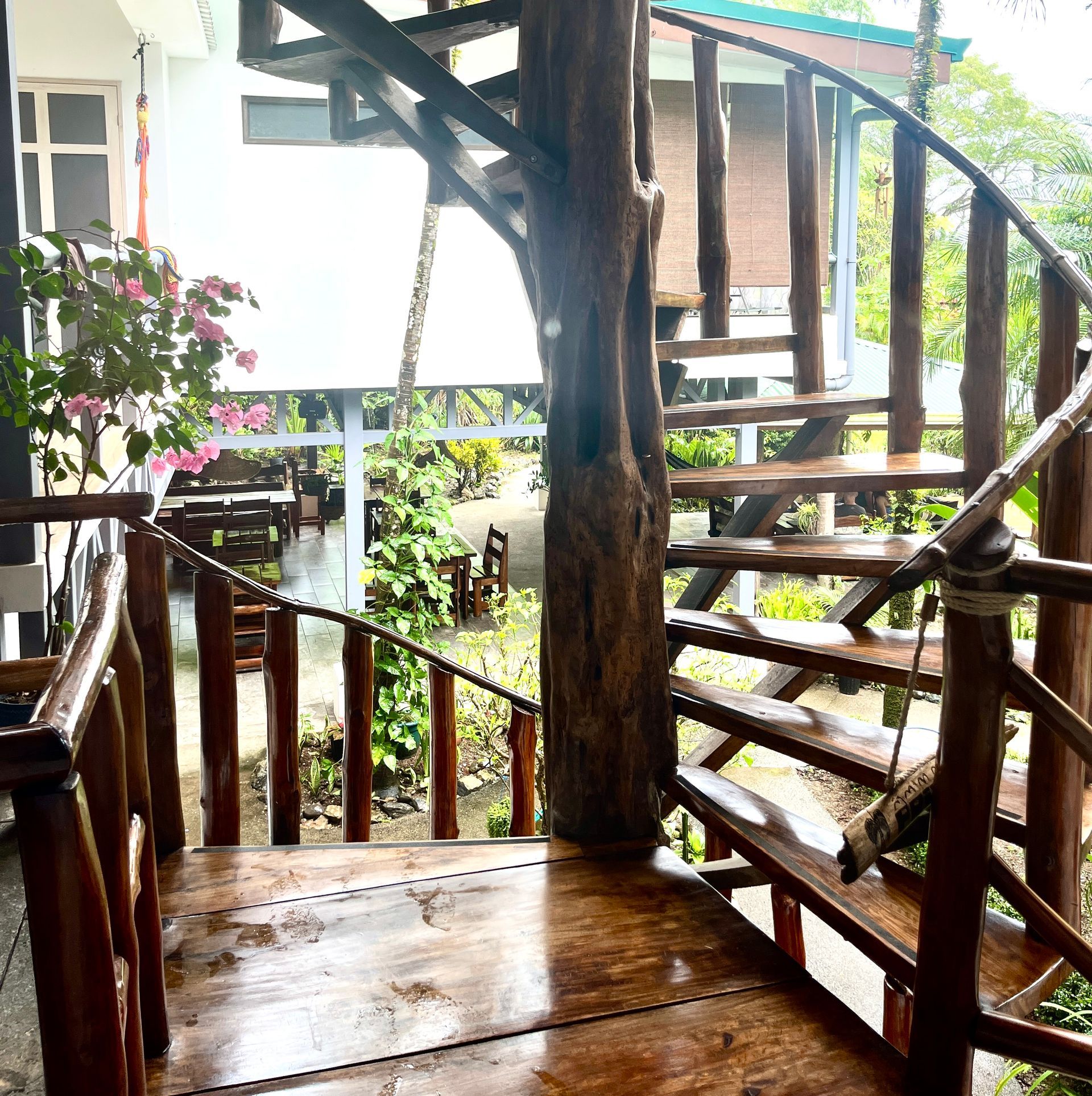 A wooden spiral staircase leading up to a house