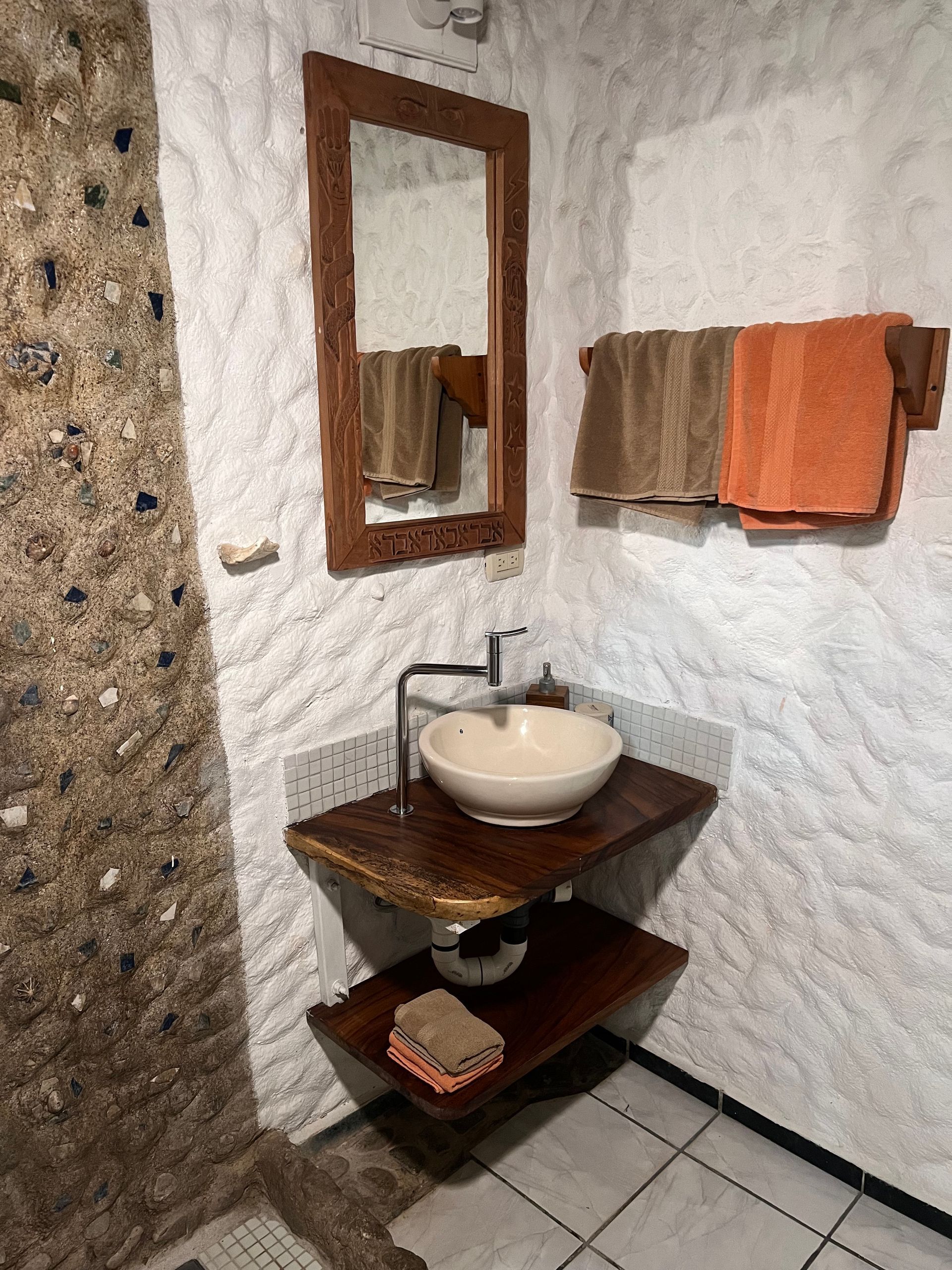 A bathroom with a sink and a mirror on the wall