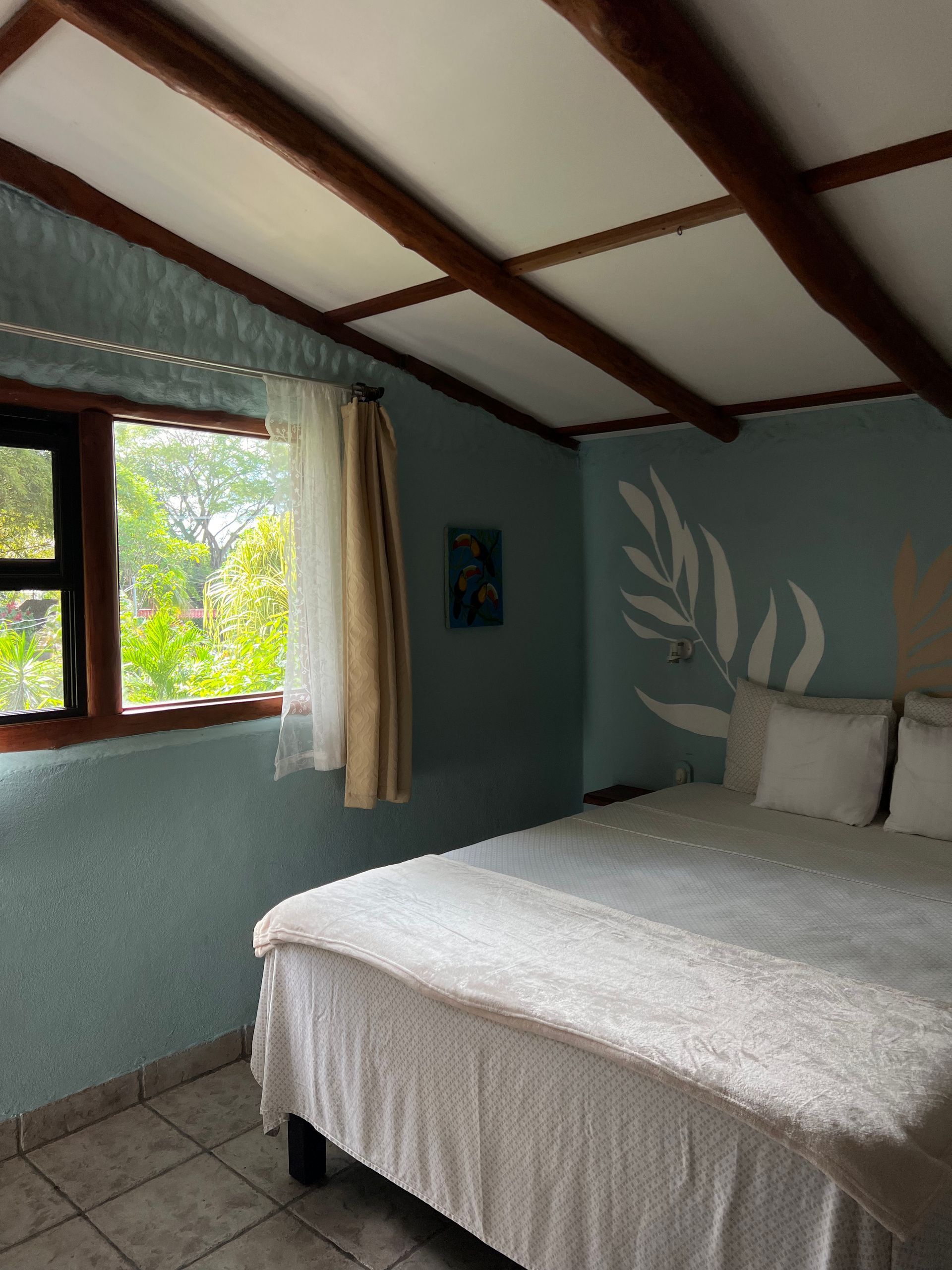 A bedroom with a large bed and a window