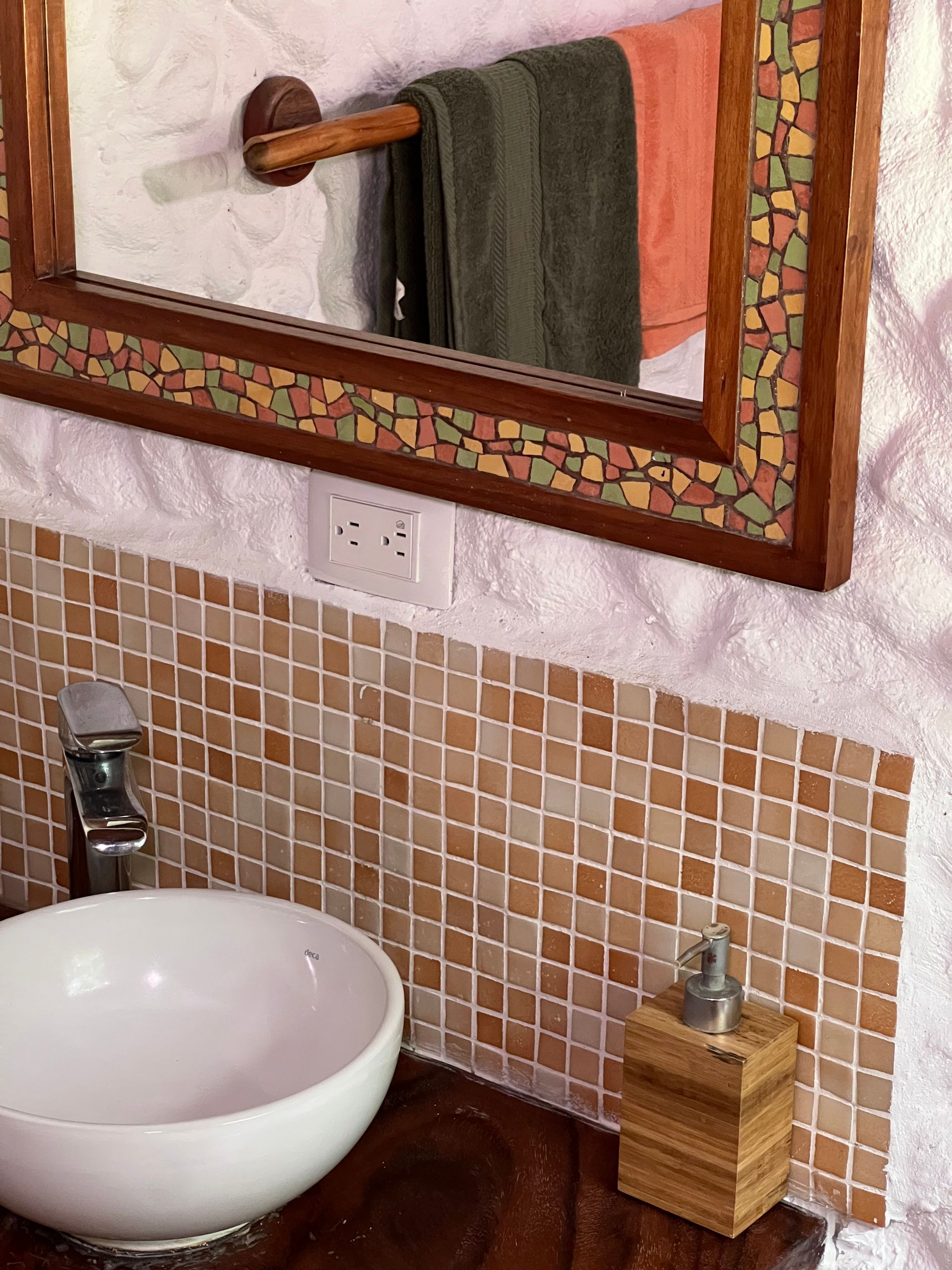 A bathroom with a sink and a mirror on the wall