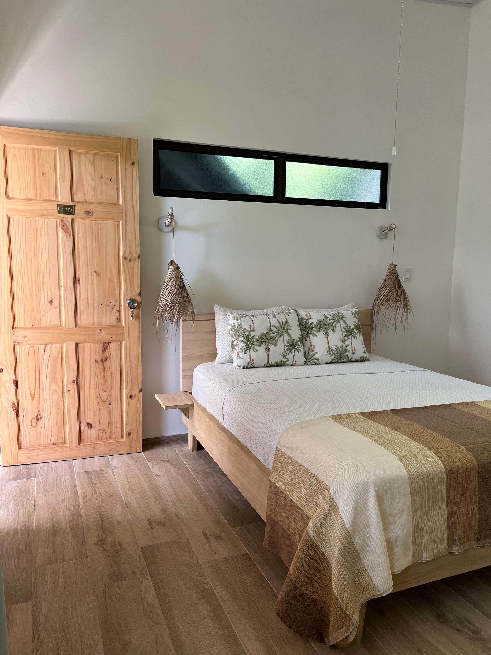 A bedroom with a bed and a wooden door