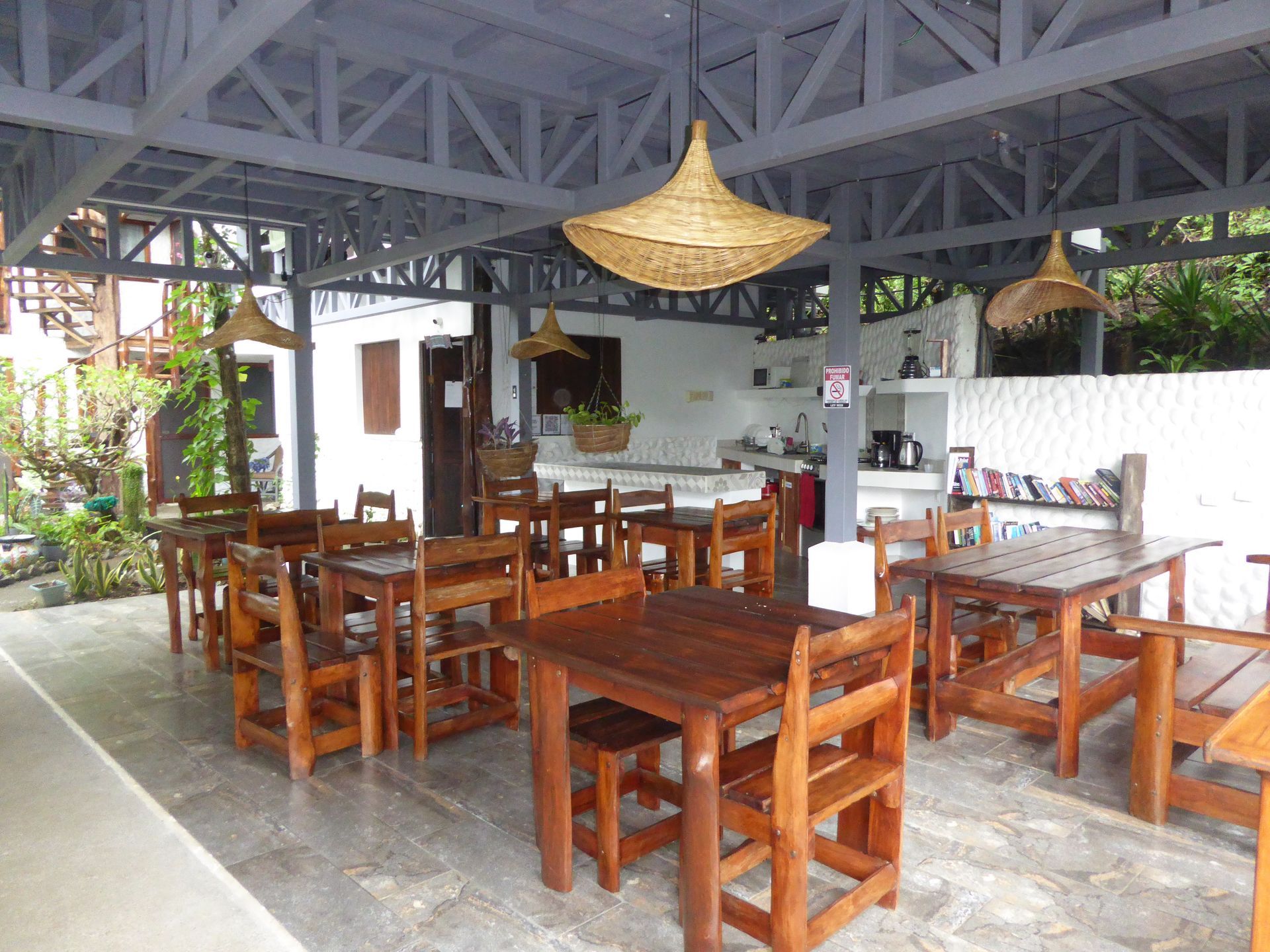 A restaurant with tables and chairs under a canopy