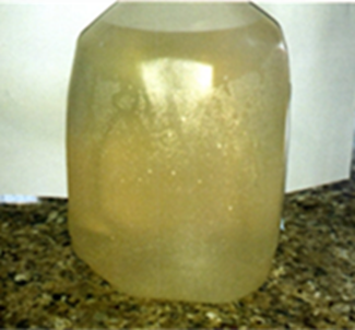 A translucent, large plastic jug filled with cloudy, yellowish liquid.