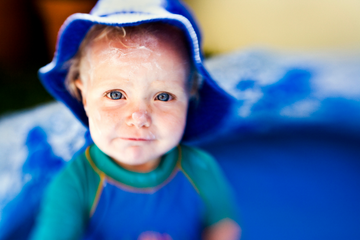 young child wearing sunscreen