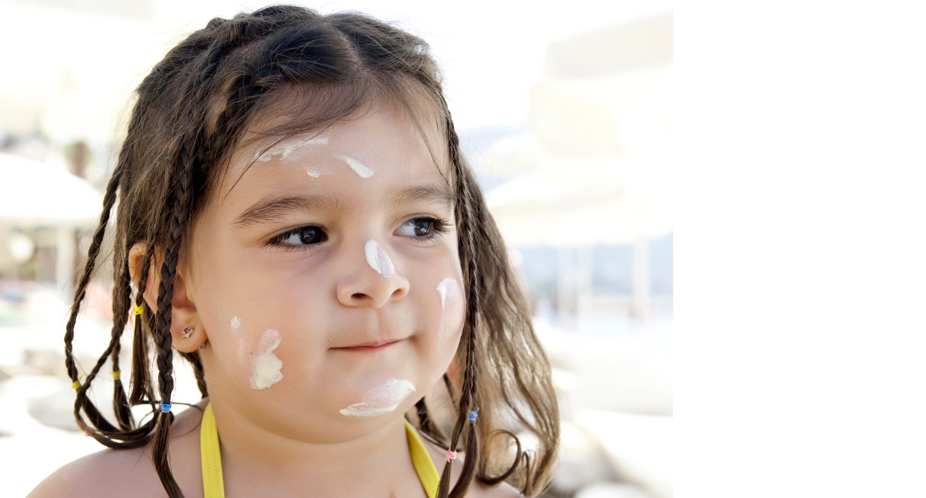 Young girl with sunscreen on