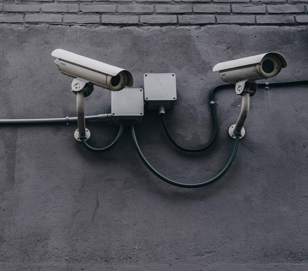 Two Security Cameras on A Wall with The Words Smile You 're on Camera — Fortress Locksmiths & Security in Lennox Head, NSW