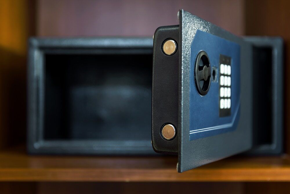A Person Is Pointing at A Keypad on A Brick Wall — Fortress Locksmiths & Security in Lennox Head, NSW