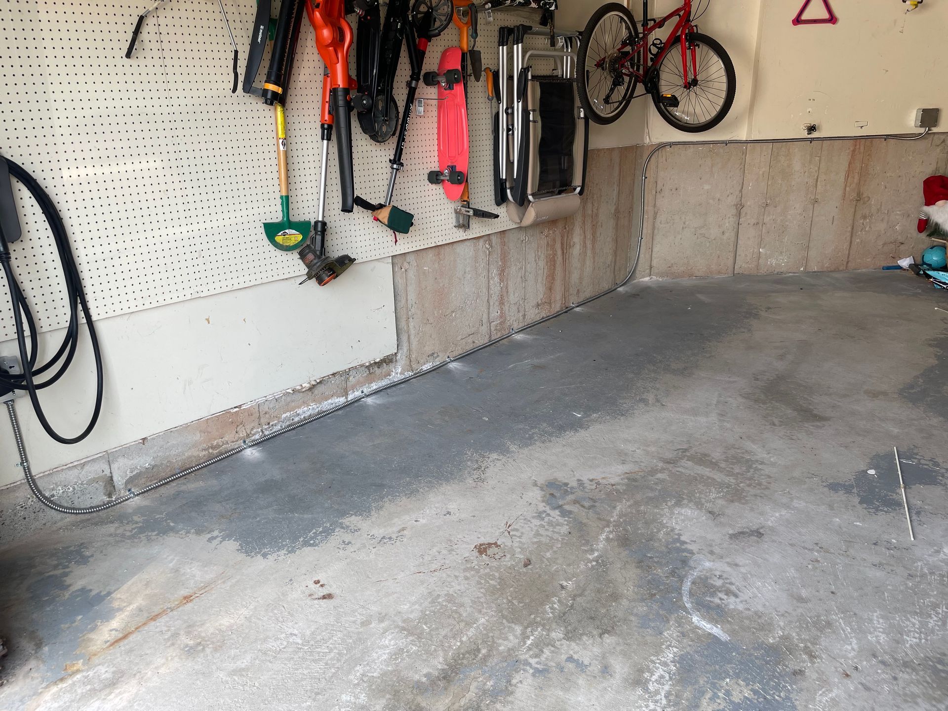 A garage with a bunch of tools hanging on the wall