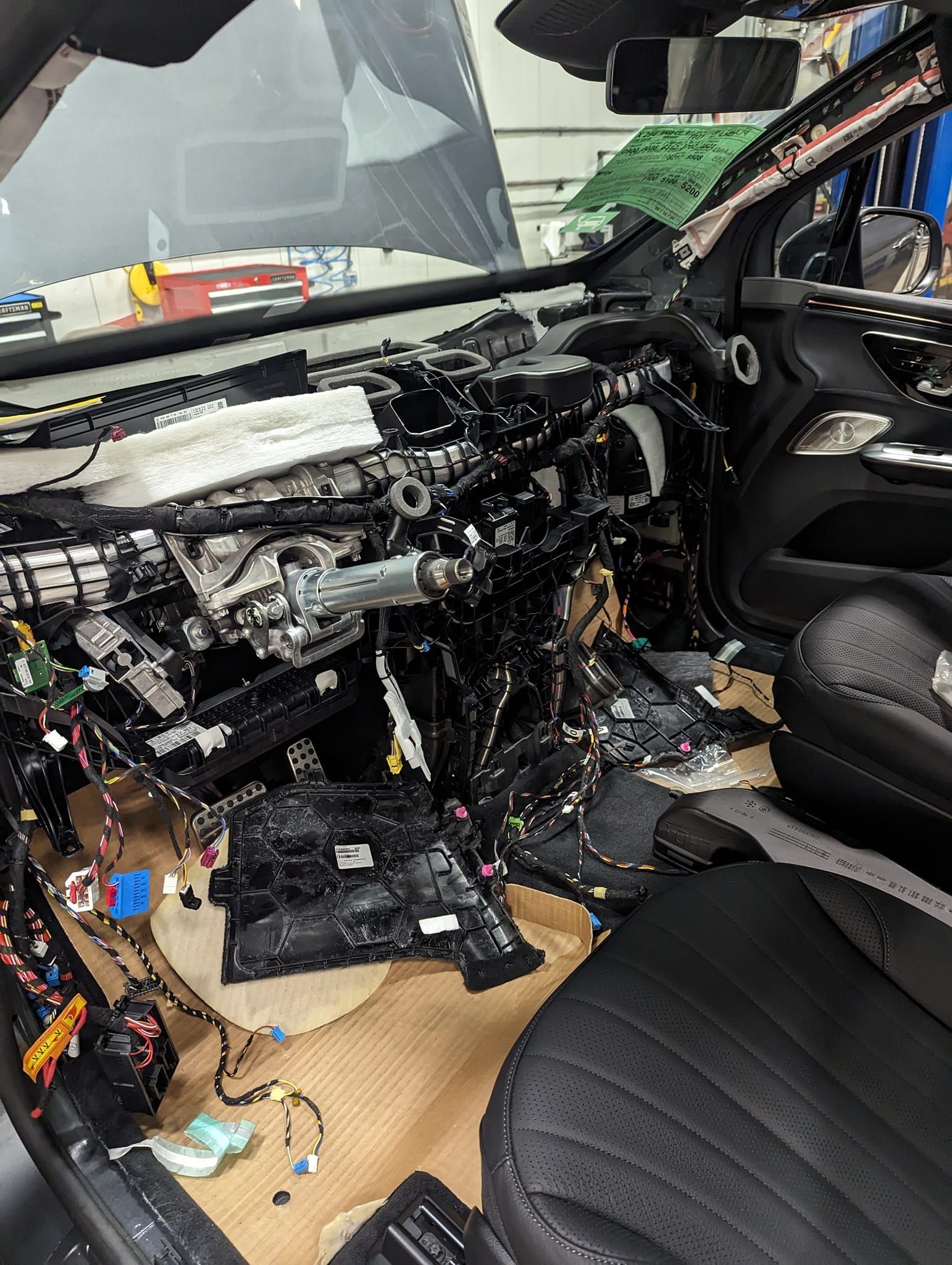 The inside of a car with a lot of wires coming out of it.