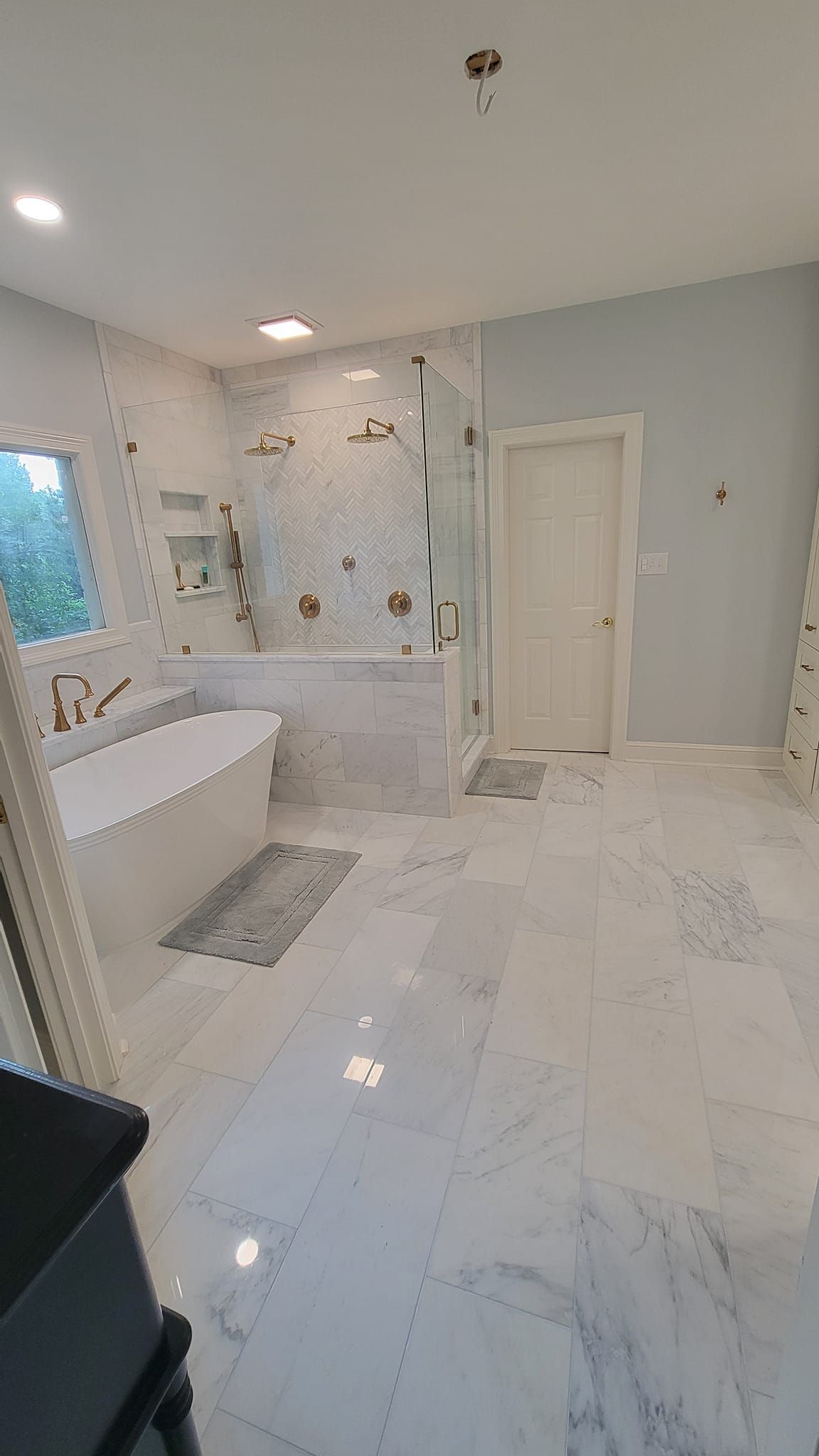 A bathroom with a toilet , sink , mirror and shower.