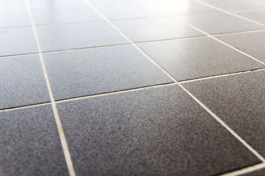 A close up of a tiled floor with white grout