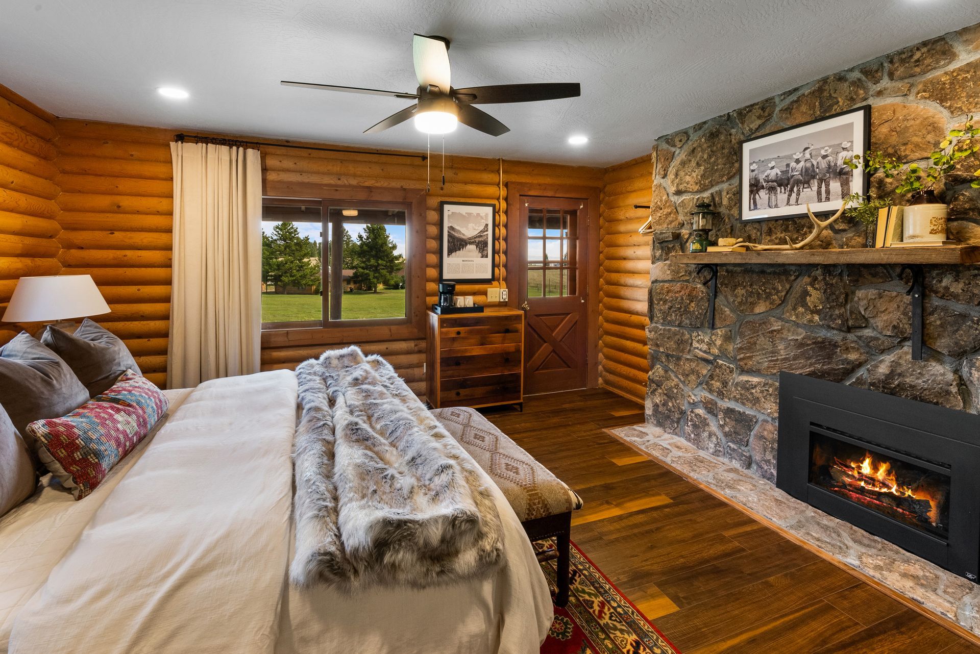 cabin bedroom with beautiful stone fireplace