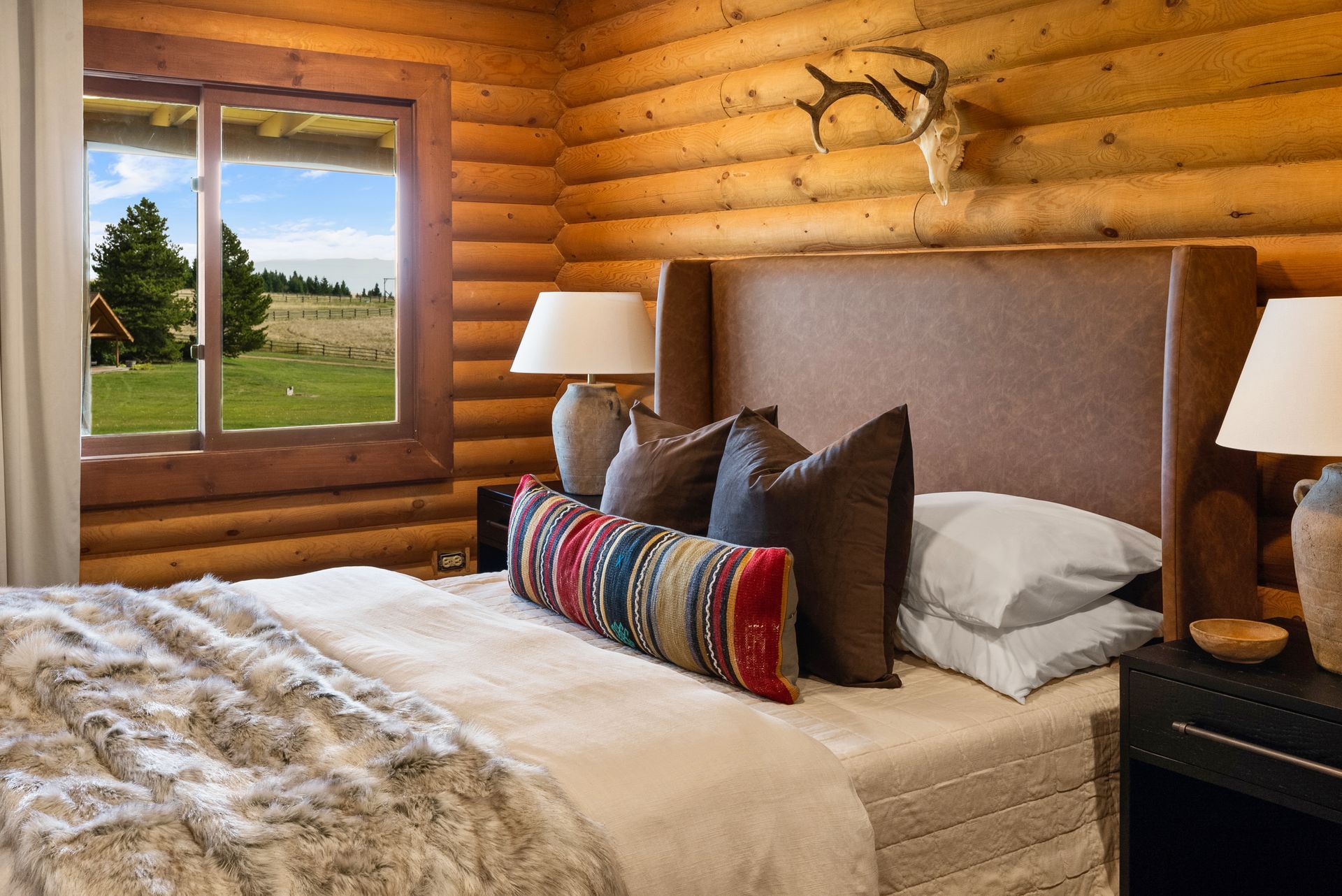 cabin bedroom with log walls and rustic decor