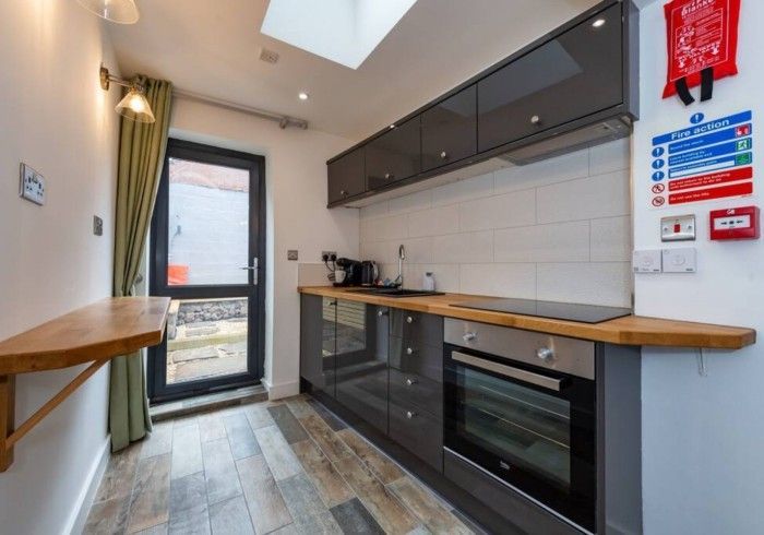 A kitchen with stainless steel appliances and a wooden counter top.