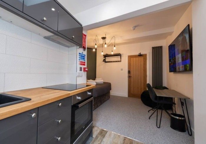 A kitchen with a flat screen tv on the wall